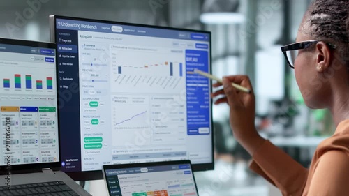 Insurance Underwriter Reviews Policy Data On Laptop Assessing Risk