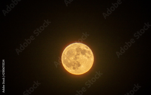 Yellow moon on a dark background at night on the island of Crete, Greece in summer