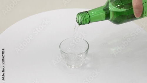 Close-up Fixed Shot of Pouring South Korean Traditional Alcohol Soju into a Glass (Korean Culture, Drink)