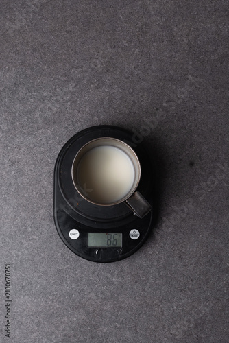Obraz na plátne Overhead view of tangzhong in a silver cup on dark background, top view of tangz