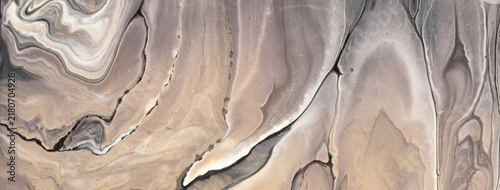 Abstract acrylic pour fluid art background in light beige and gray tones with marble texture and wavy pattern
