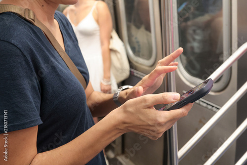 Fotografía Woman using a smartphone for mobile communication and app browsing while commuti