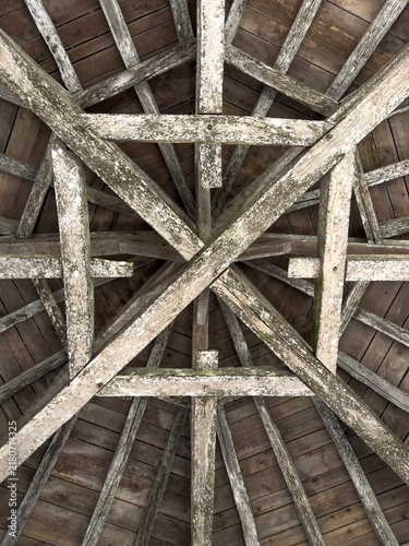 Star-patterned timber roof trusses inside the attic of St. Peter collegiate church, Gers, La Romieu, France