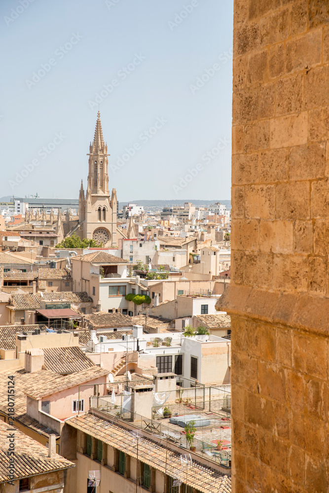 Fototapeta premium Panorama of the rooftops of Palma, Mallorca, Spain, seen from a corner of the Catedral de Mallorca, with the tower of Església de Santa Eulàlia in the distance.