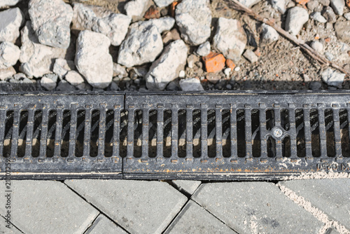 фотографія A drainage system runs along a paved area at a construction site