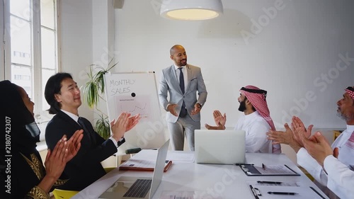 Business professionals discussing project during international office meeting