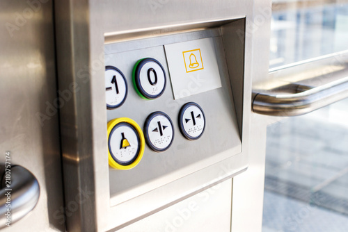 Close Up of Elevator Control Panel with Braille Buttons and Emergency Bell