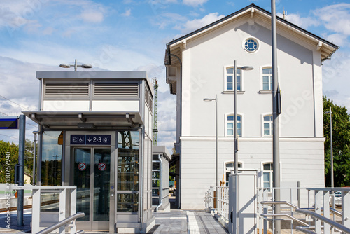 Glass Elevator Unit Next to Historic Train Station Building