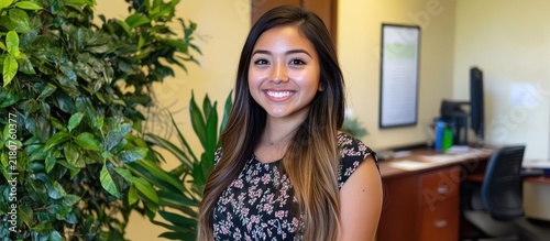 Portrait of a Smiling Young Professional Woman in a Modern Bright Office with Indoor Plants