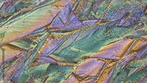 Iridescent crystal texture macro abstract surface with metallic iridescent mineral geological fracture pattern close up view
