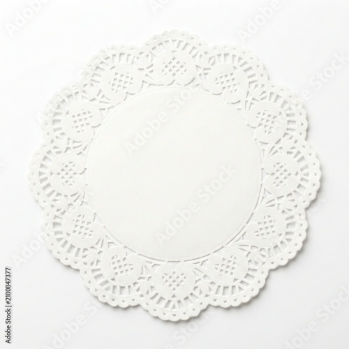 White paper doily with intricate lace pattern isolated on white background