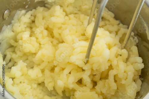 Photography Making mash potato with hand potato masher