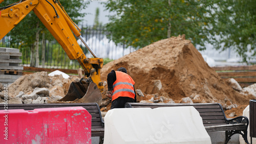 Bild auf Leinwand Urban construction area with temporary safety barriers, exposed ground and ongoi
