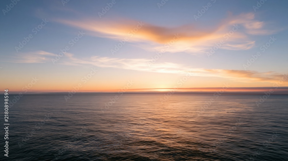 Fototapeta premium Calm ocean under a soft clouded sky at sunset, featuring muted teal water and a glowing peach horizon for meditation and travel backgrounds