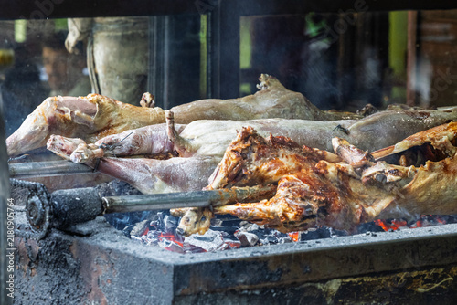 Whole Roasted Lamb On Spit Over Hot Coals At Traditional Outdoor Barbecue Roast