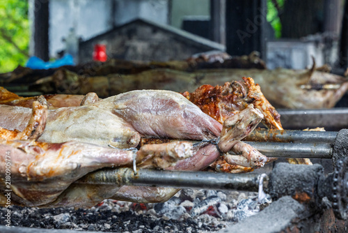 Whole Roasted Lamb On Spit Over Hot Coals At Traditional Outdoor Barbecue Roast