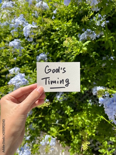 God's timing - vertical card with christian concept and blue flowers on background, biblical faith and religion