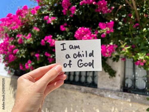 I am a child of God - christian text with pink flowers background, biblical faith concept