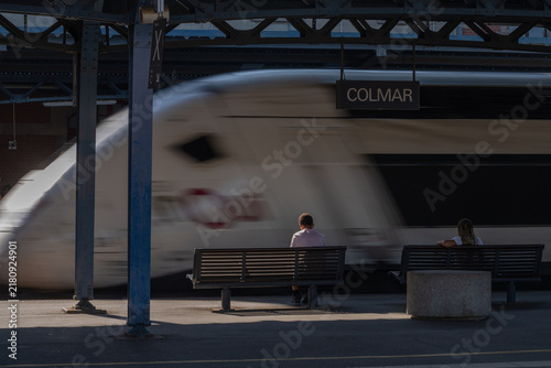 Train station with passengers waiting for train in Colmar in afternoon