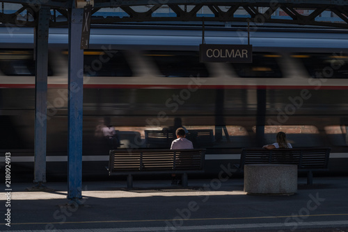 Train station with passengers waiting for train in Colmar in afternoon