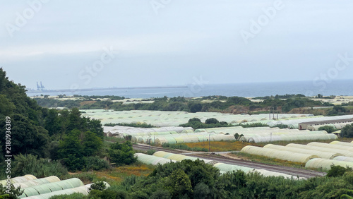 High Angle View of Coastal Greenhouse Agriculture Fields Near Railway and Sea