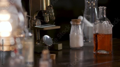 Victorian scientist placing a sample under a microscope