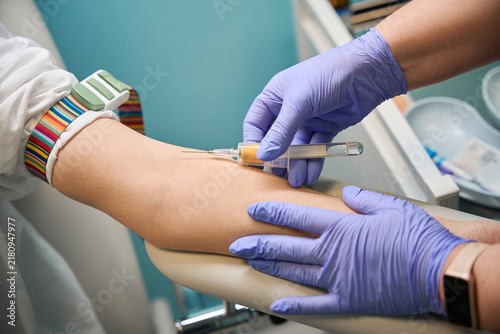 Medical professionals performing blood draw in clinic