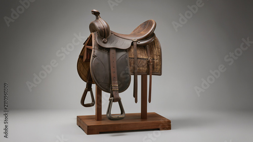 Brown Leather Saddle Displayed on Wooden Stand