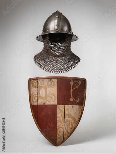 Helmet and Chainmail Displayed Above Painted Shield
