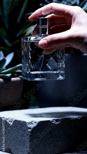Hand Holding Glass Perfume Bottle