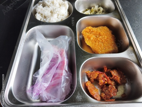 Принти на полотні Meal served in a metal tray containing rice a fried cutlet and meat portions wit
