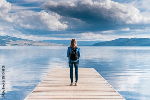 Female Explorer Enjoying a Breathtaking View at a Serene Lakeside Location