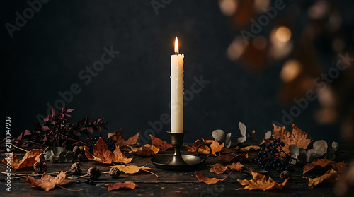Single burning candle in rustic candlestick holder surrounded by autumn leaves