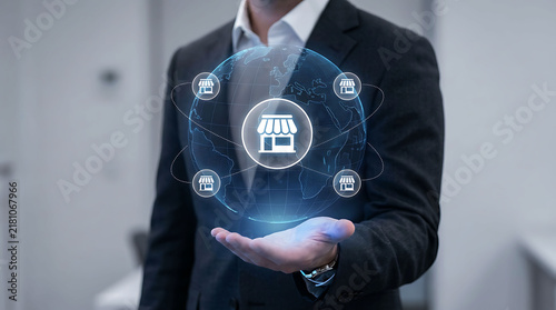 Businessman holding glowing global franchise network digital hologram concept