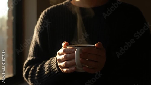 Person Holding Steaming Hot Drink Mug in Cozy Sweater. 4K Video