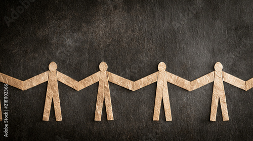 Paper Cutout Human Figures Holding Hands In Long Continuous Chain

