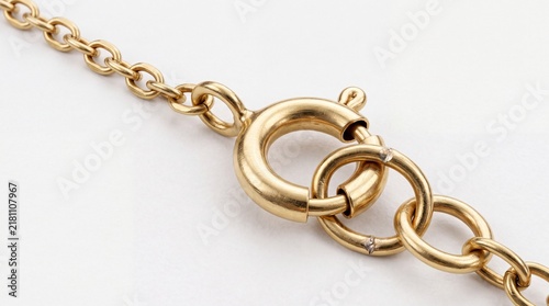Macro Close Up of a Golden Chain Necklace with Round Spring Ring Clasp Fastener on White Background