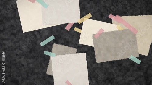 Stop motion animation of torn paper scraps and colorful washi tape drifting on a dark textured background