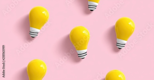 Bright yellow light bulbs symbolizing new ideas and innovation on a pink background