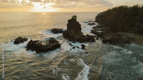 Rugged rock formations against sunset sky at Ostional Beach shore in Costa Rica