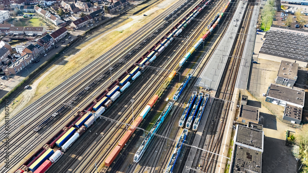 Obraz premium Railroad, train tracks and trains aerial drone view from above, railway station in Venlo, the Netherlands, transportation, logistics and public transport infrastructure 