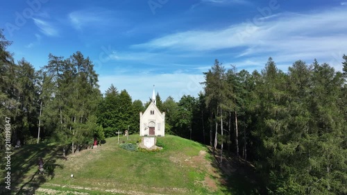 Aerial mountain Chapel St Michael Archangel Blizne . South eastern Poland. Historic mountain valley village with 15th century wooden All Saints Church. Agriculture land, rivers, forest and rural farm.