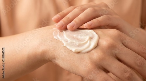 Close up of hands applying moisturizer as part of a skincare routine promoting healthy skin and hydration