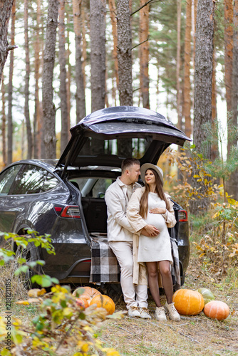 Photography A loving couple expecting a baby enjoys a beautiful autumn day in the woods, sur