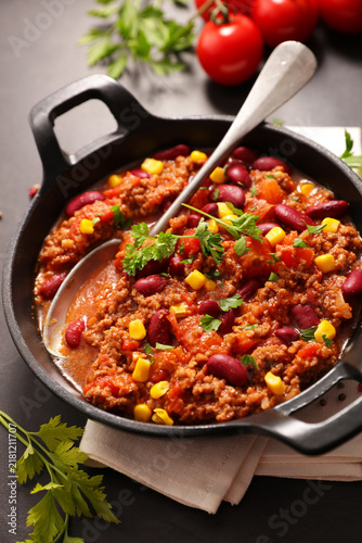 Traditional Chili Con Carne with Ground Beef, Kidney Beans, Corn and Tomatoes in Skillet