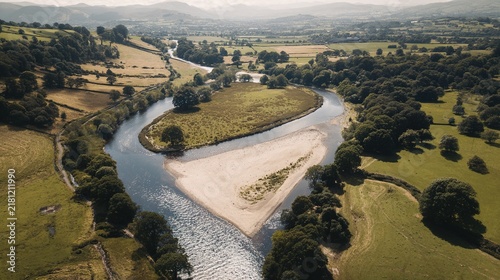 sandbar. Aerial view of a river split by a sandbar, creating two streams through green landscape. travel magazines, destination branding, designed for outdoor magazines and nature guides.