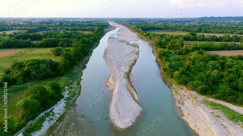sandbar. Aerial view of a river split by a sandbar, creating two streams through green landscape. travel magazines, destination branding, designed for outdoor magazines and nature guides.