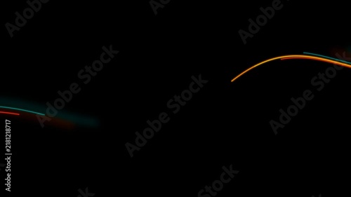 Abstract neon light streaks in dim orange and blue hues create a dynamic motion blur against a dark night backdrop. Perfect for urban and nightlife themes.