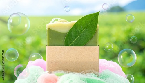 Natural soap bar with green leaf and bubbles outdoors.