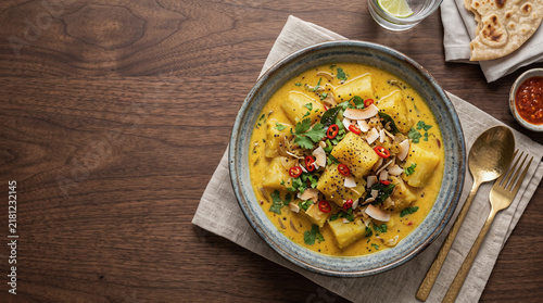 African stew dish: Cassava in coconut milk, on a table seen from above with copy space, ad image traditional African food